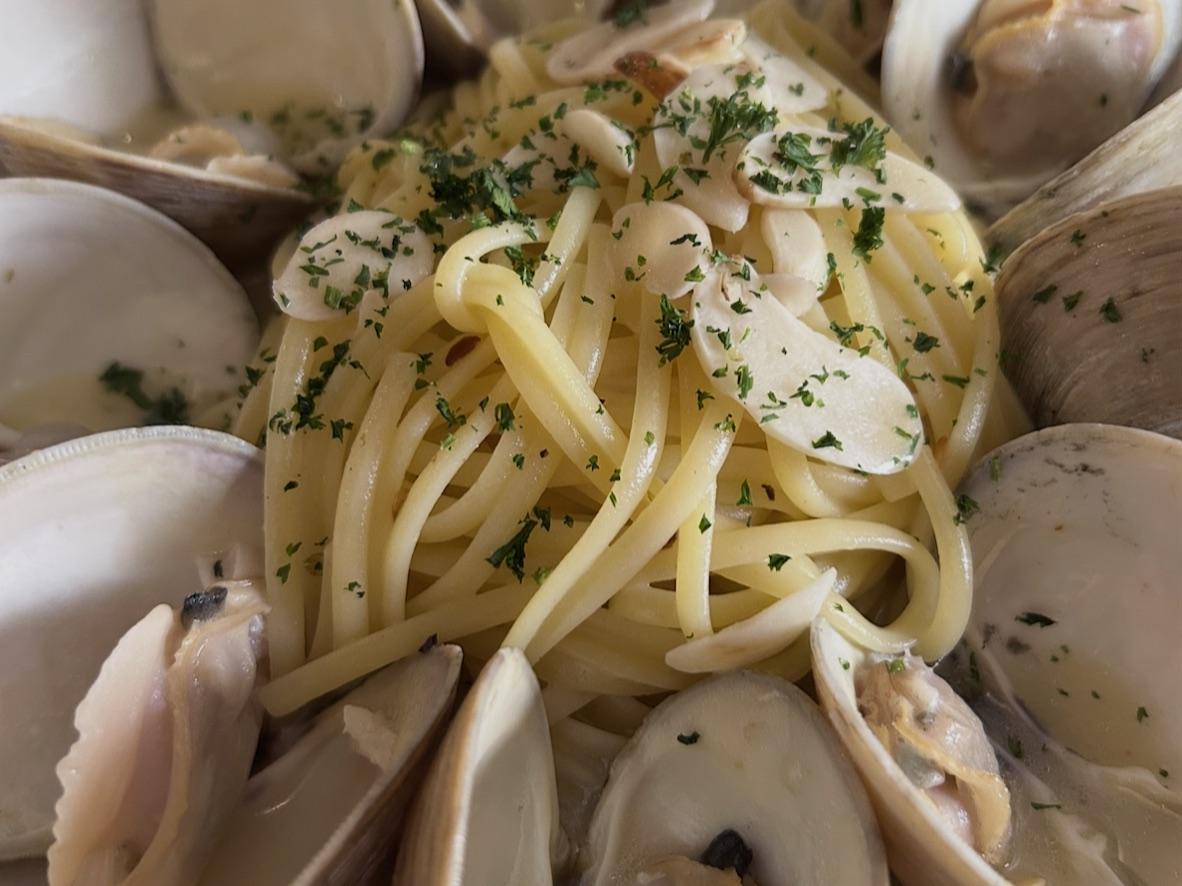 Linguine with opened clams in a garlic white wine sauce with chopped parsley