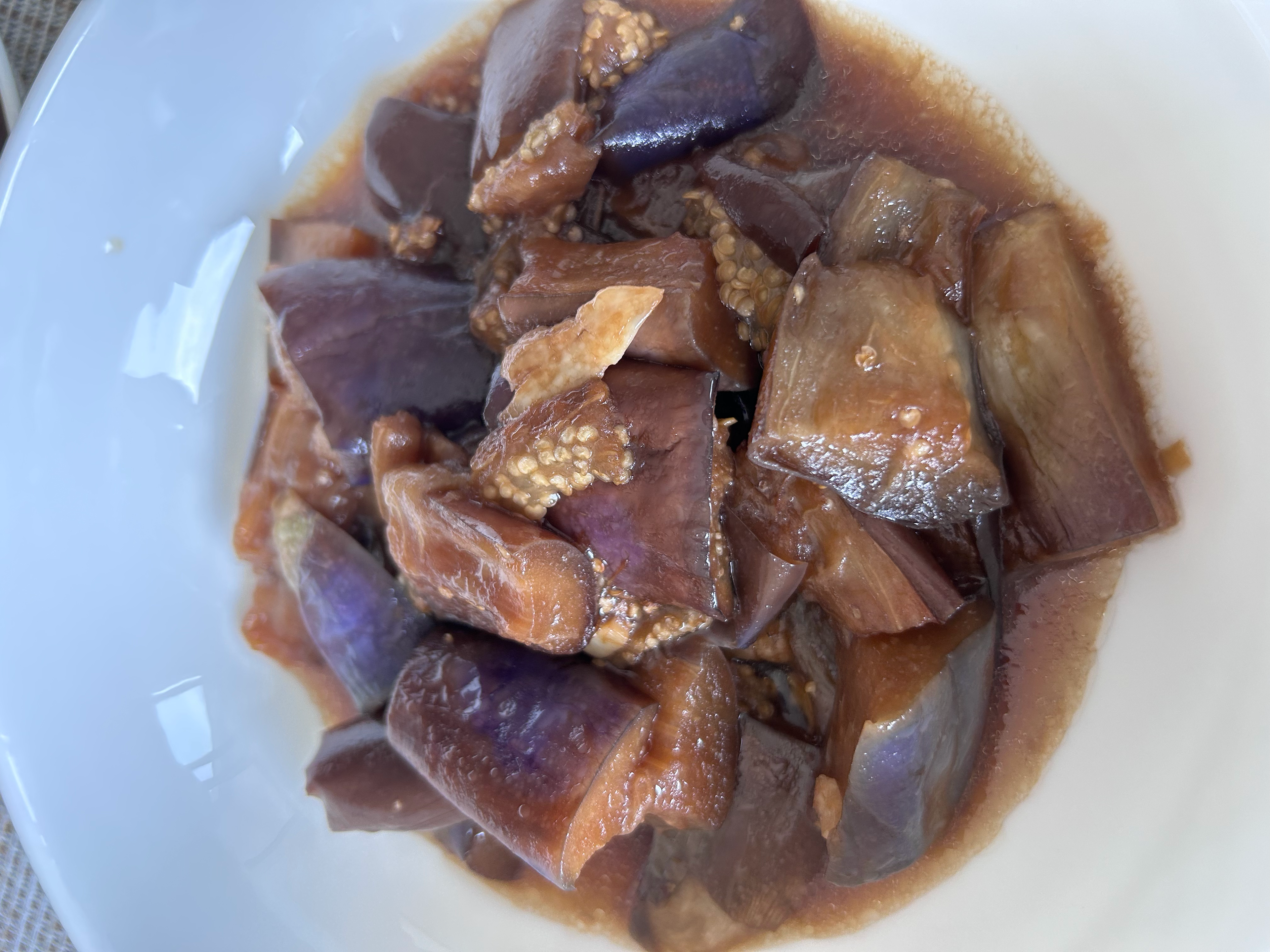 Shanghai-style braised eggplant with sliced garlic in a brown soy and black vinegar sauce