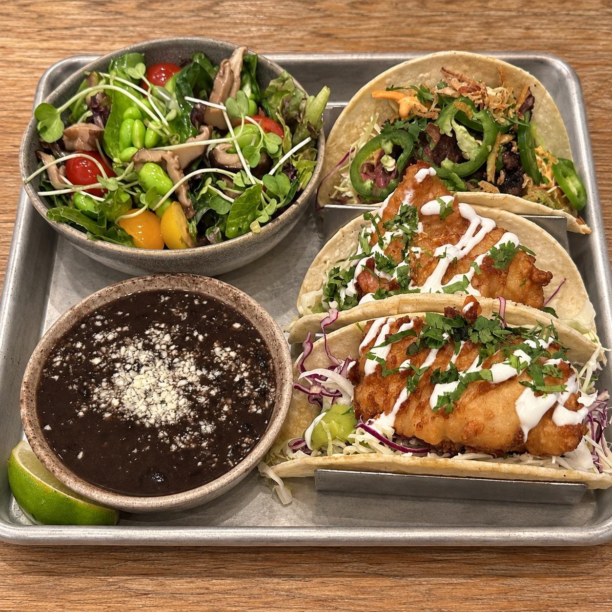 Crispy fish and sriracha steak tacos with black beans and shiitake edamame salad